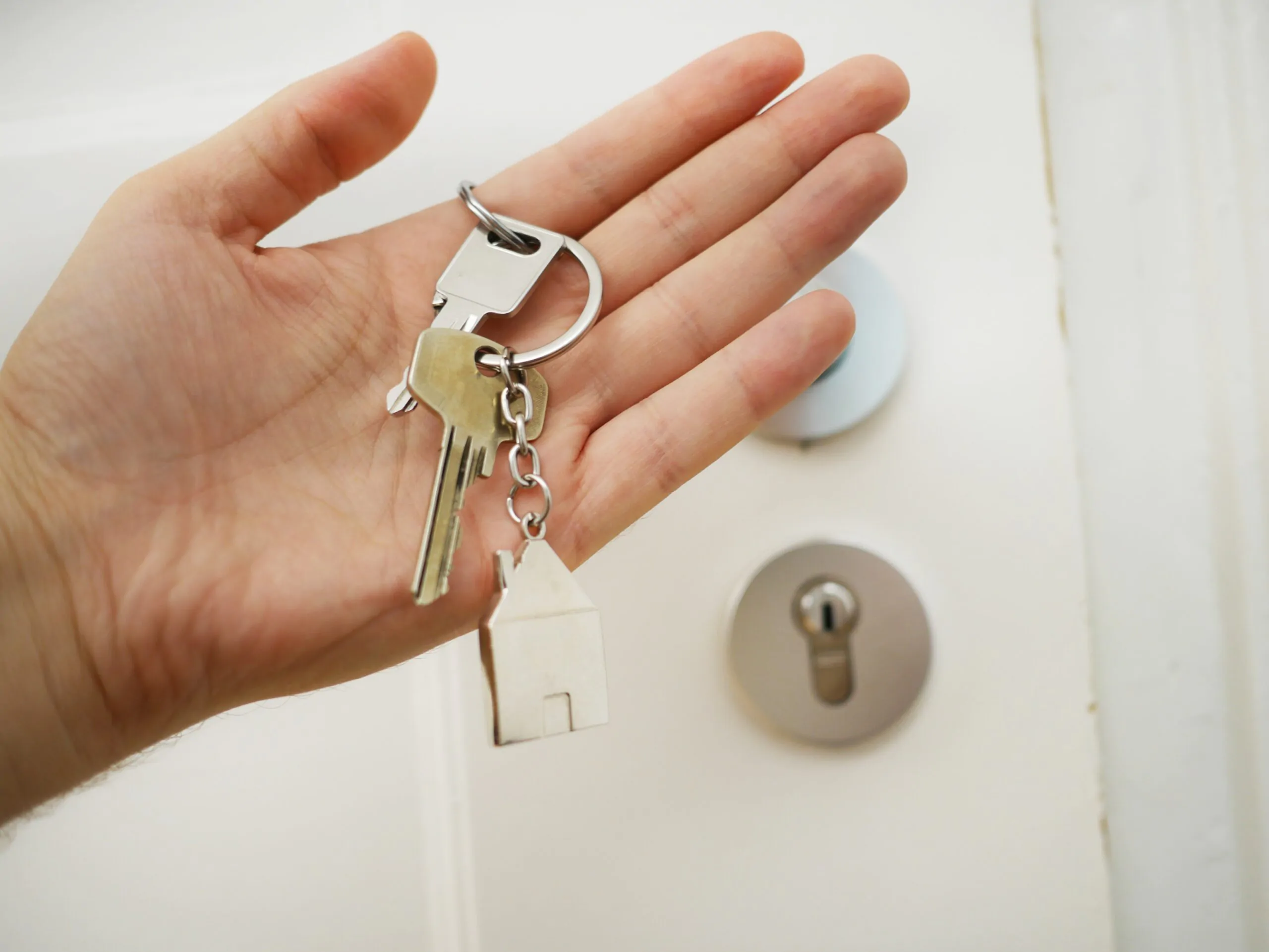 Person holding house keys in their hand